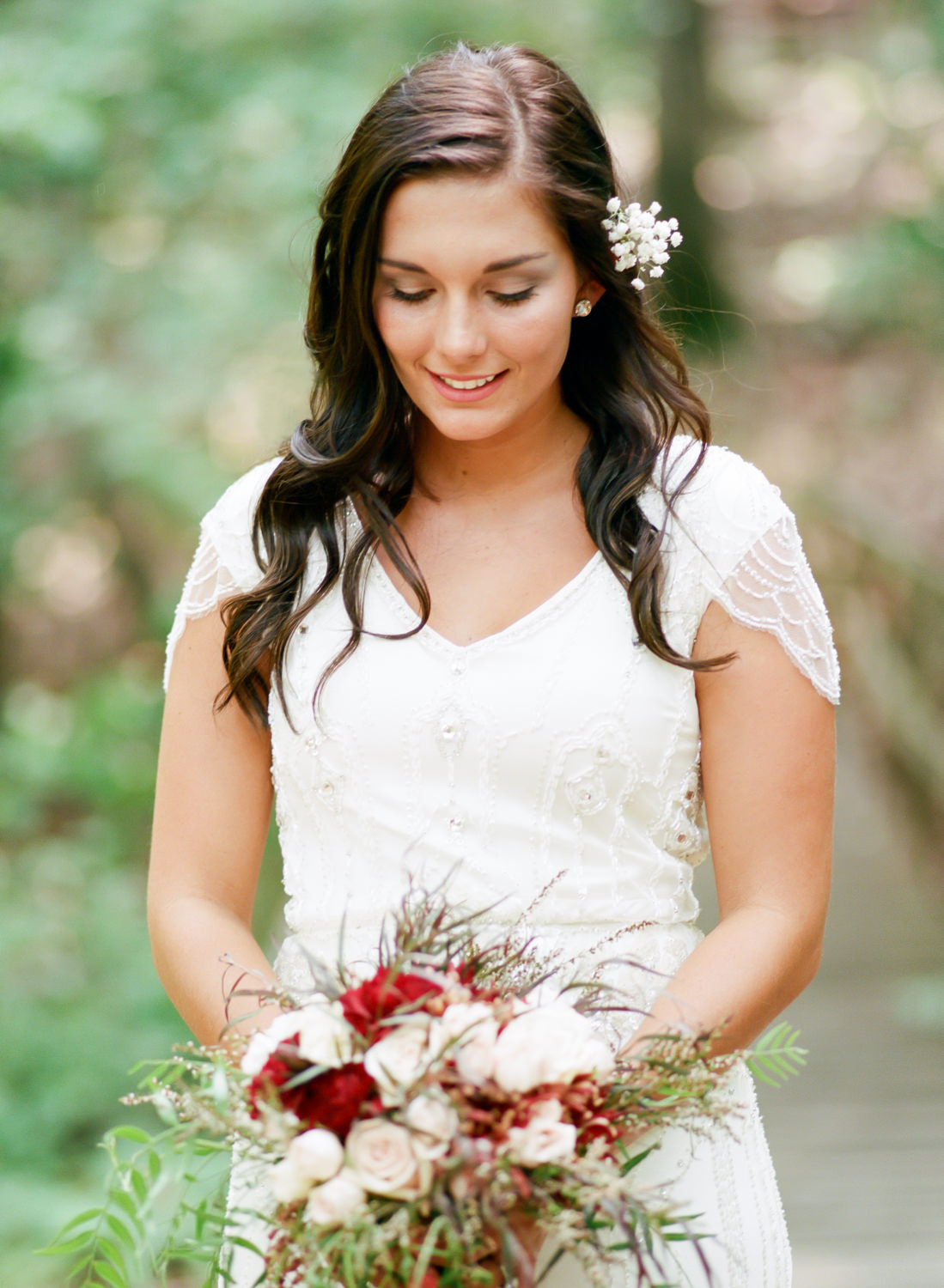 bride smiling at bouquet, St. Louis wedding photography, Erica Robnett Photography