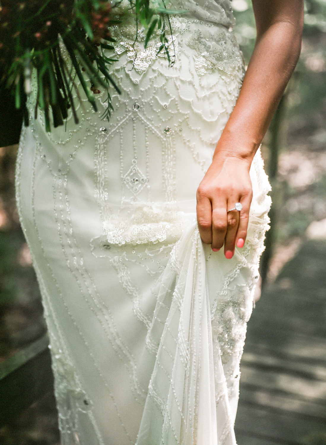 bride with diamond ring holding up beaded gown, Erica Robnett Photography, St. Louis wedding photography