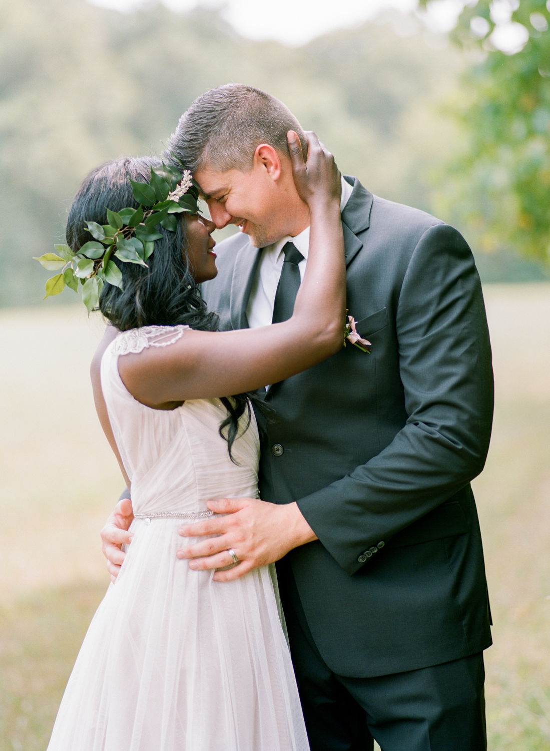 Bride and groom snuggling in a field, Erica Robnett Photography, film wedding photography