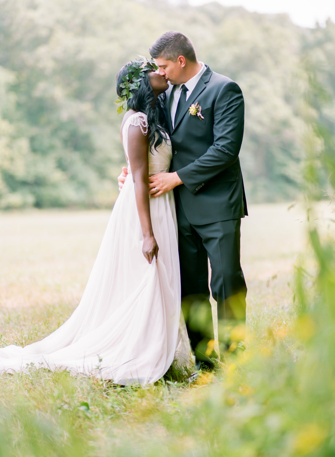 bride and groom kissing in a field, St. Louis fine art wedding photography