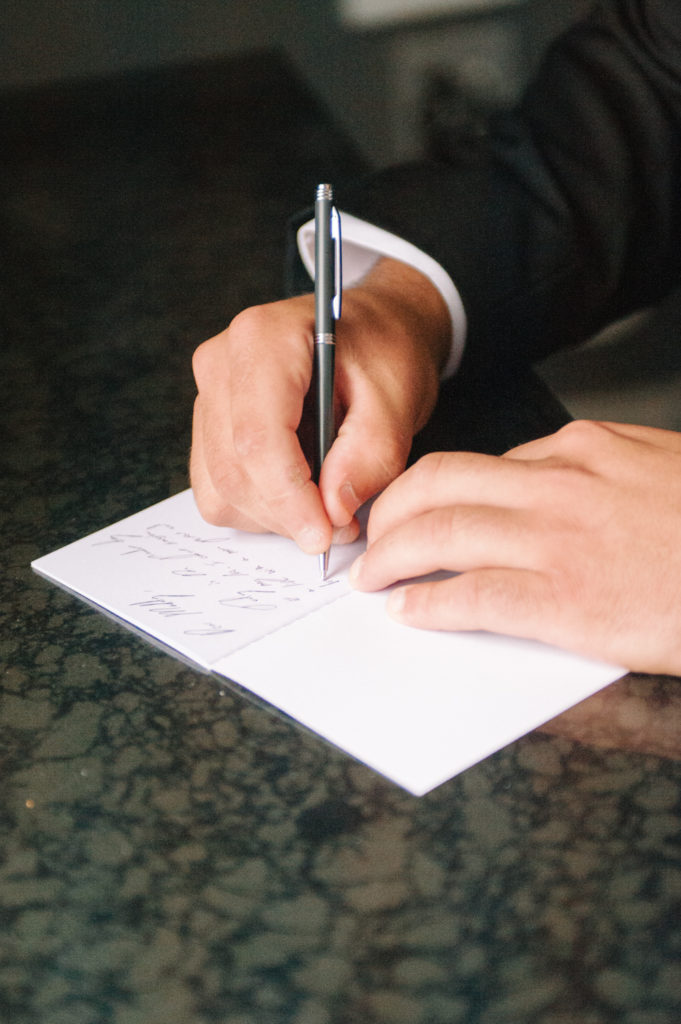 Groom writing letter to bride, St. Louis wedding photographer