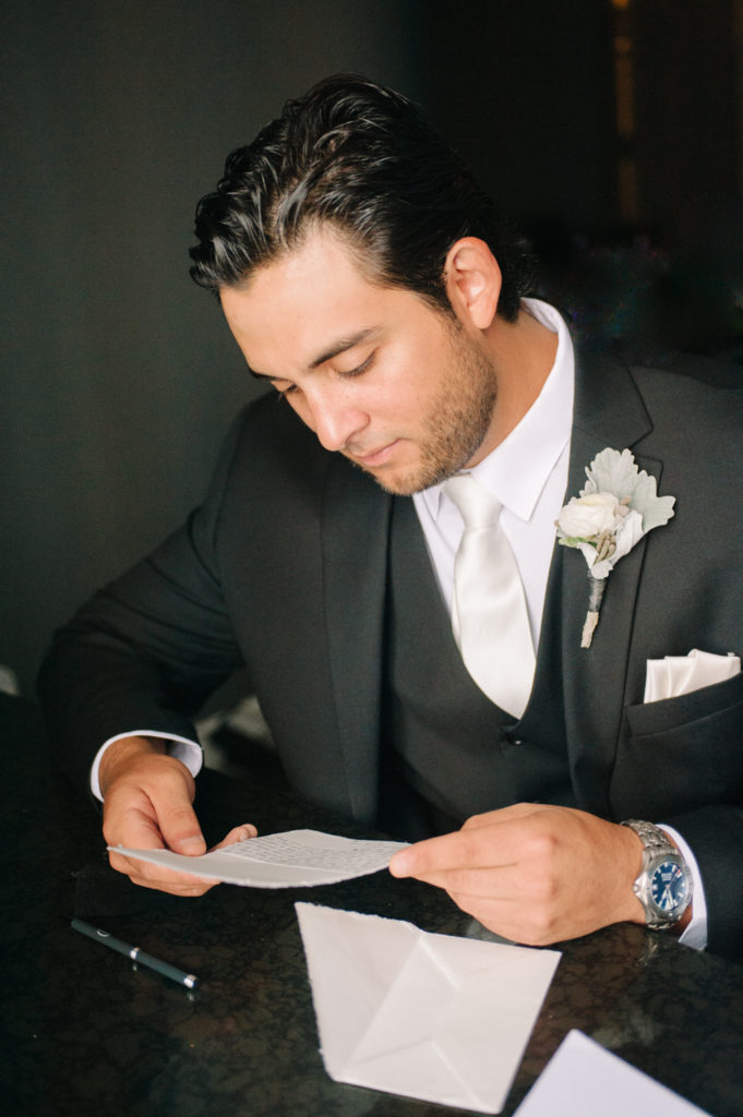 Groom reading letter from bride, St. Louis wedding photographer