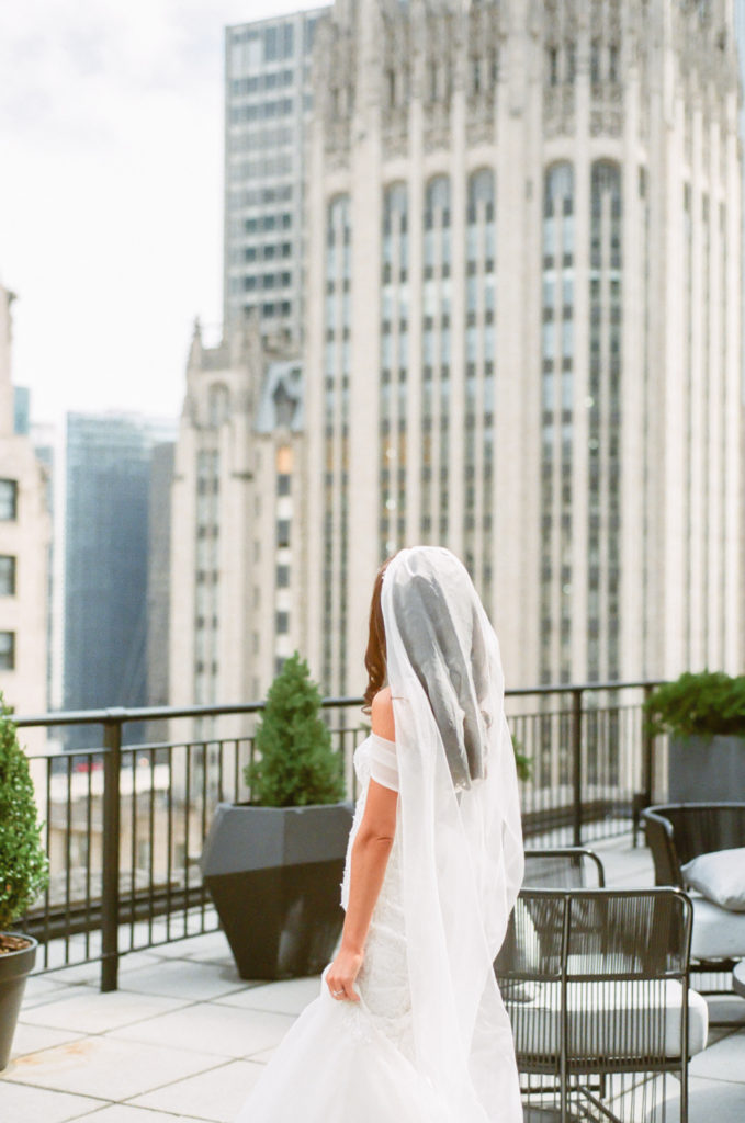 Bride at Gwen Hotel with Chicago skyline, Chicago fine art wedding photographer
