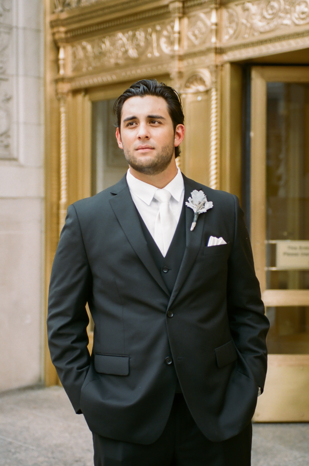 Chicago groom in front of gold door on Michigan Avenue, Destination fine art wedding photography