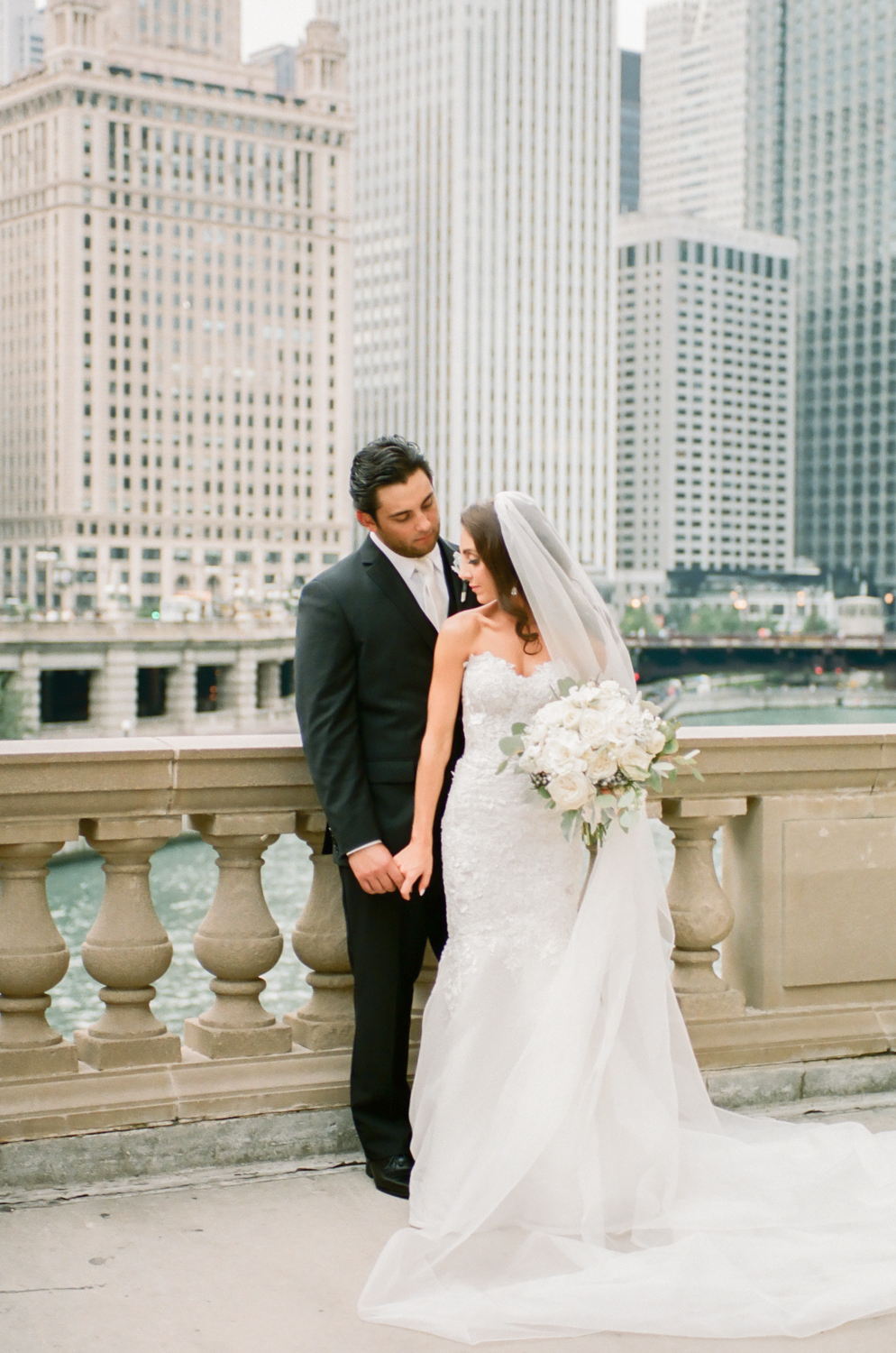 Bride and groom by Chicago canal on Michigan Avenue, Destination fine art wedding photographer