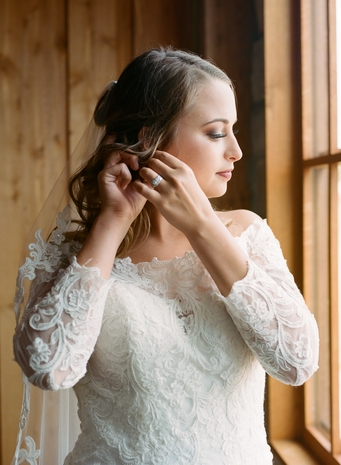 bride wearing lace gown getting ready at Mighty Oak Lodge, St. Louis Fine Art Film Wedding Photographer Erica Robnett Photography