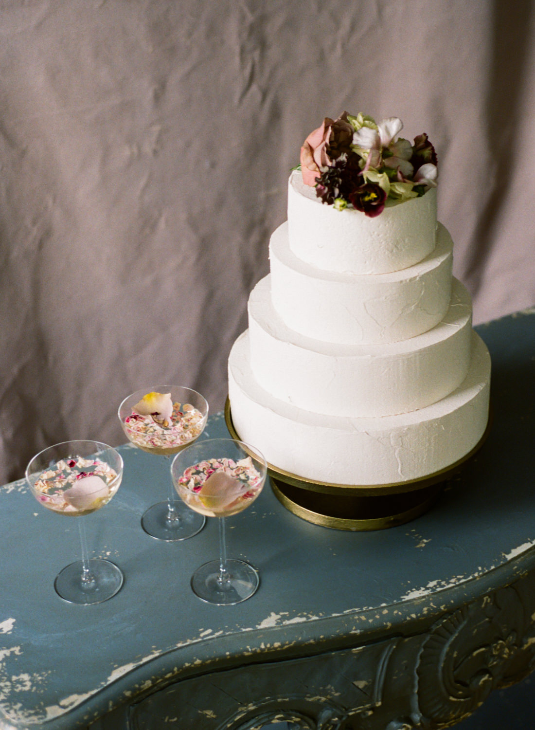 Classic white tier wedding cake with mauve flowers and pink flower signature drinks, St. Louis Fine Art Film Wedding Photographer Erica Robnett Photography