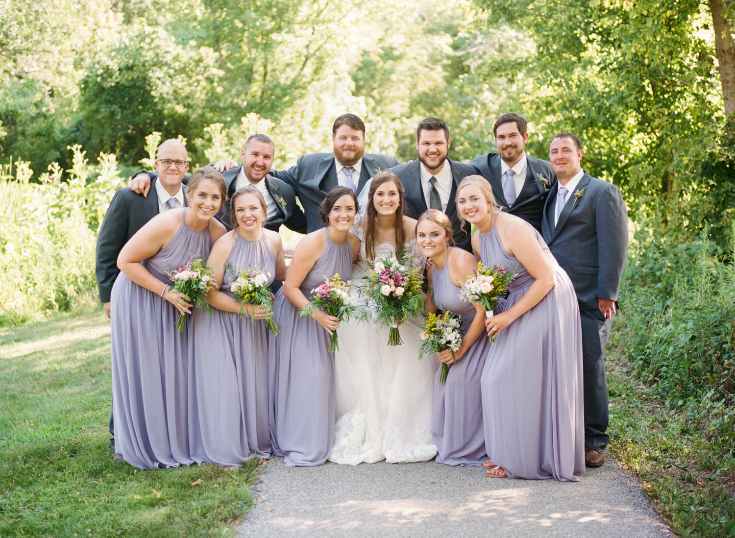 Wedding party in lavender gowns and dark gray suits; St. Louis wedding photographer