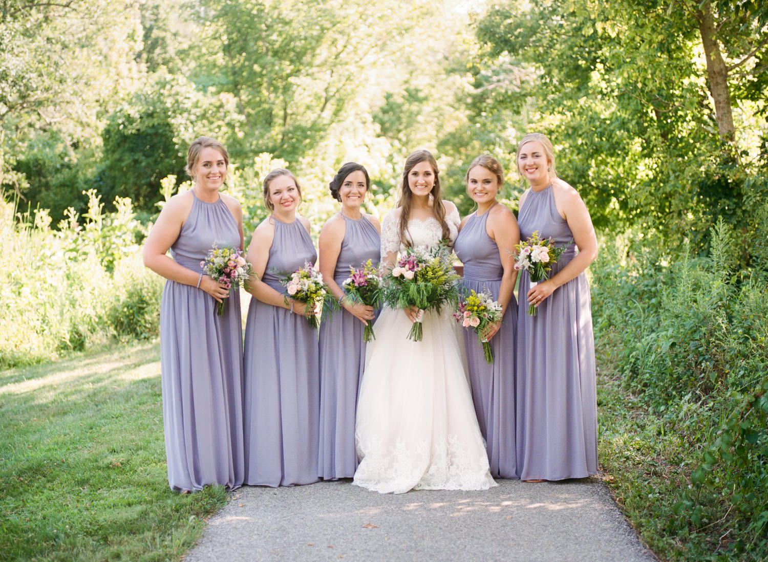 Bride and bridesmaids in lavender dresses; St. Louis wedding photographer