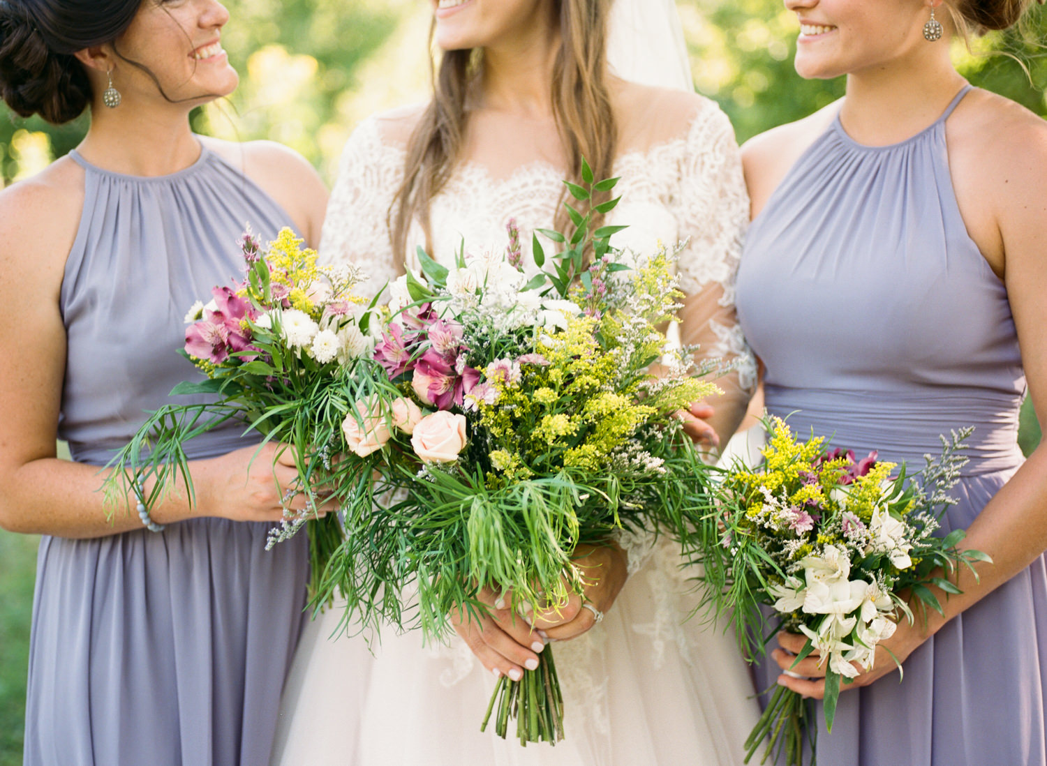 Bride and bridesmaids with wildflower bouquets; St. Louis fine art film wedding photographer Erica Robnett Photography