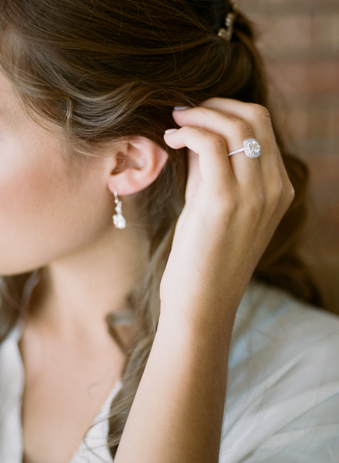 Bride putting on earrings; St. Louis wedding photographer Erica Robnett Photography