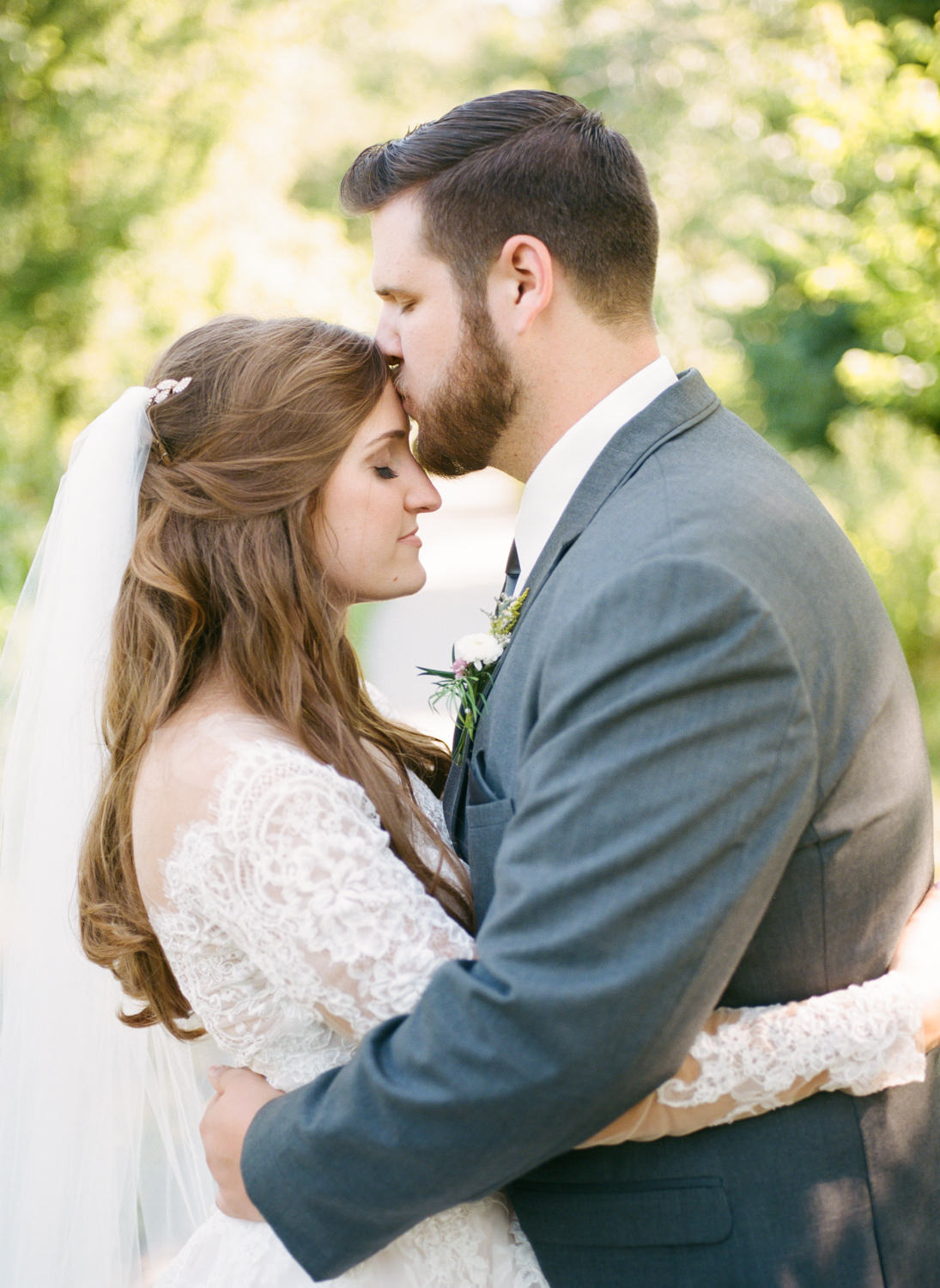 Groom kissing bride; St. Louis fine art film wedding photographer Erica Robnett Photography