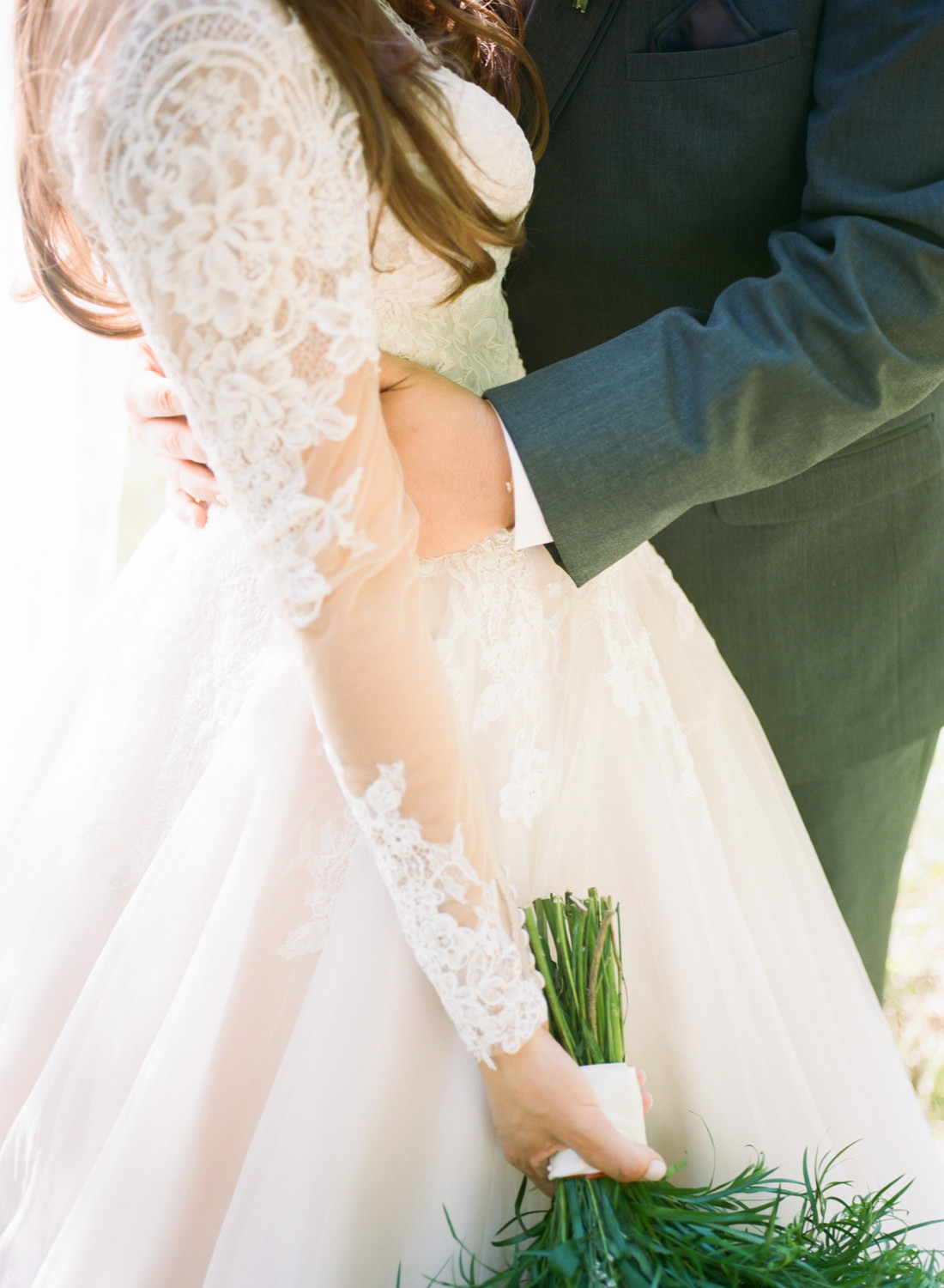 Groom's arms around bride; St. Louis fine art film wedding photographer Erica Robnett Photography