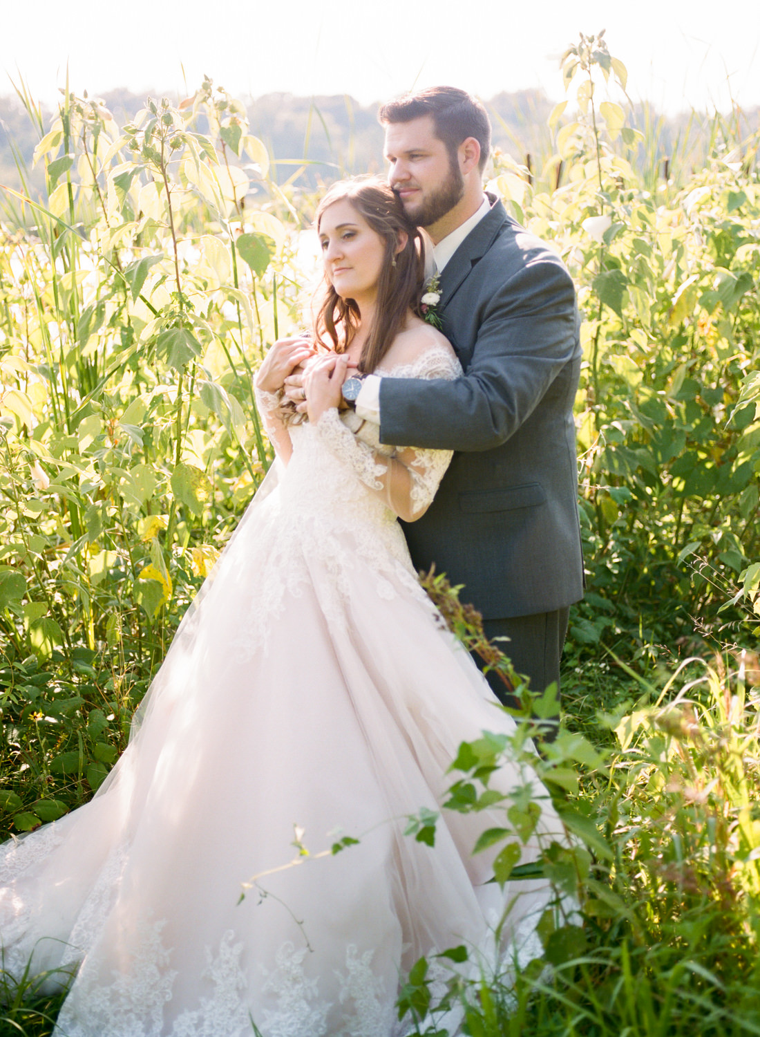 Bride and groom in field; St. Louis fine art film wedding photographer Erica Robnett Photography