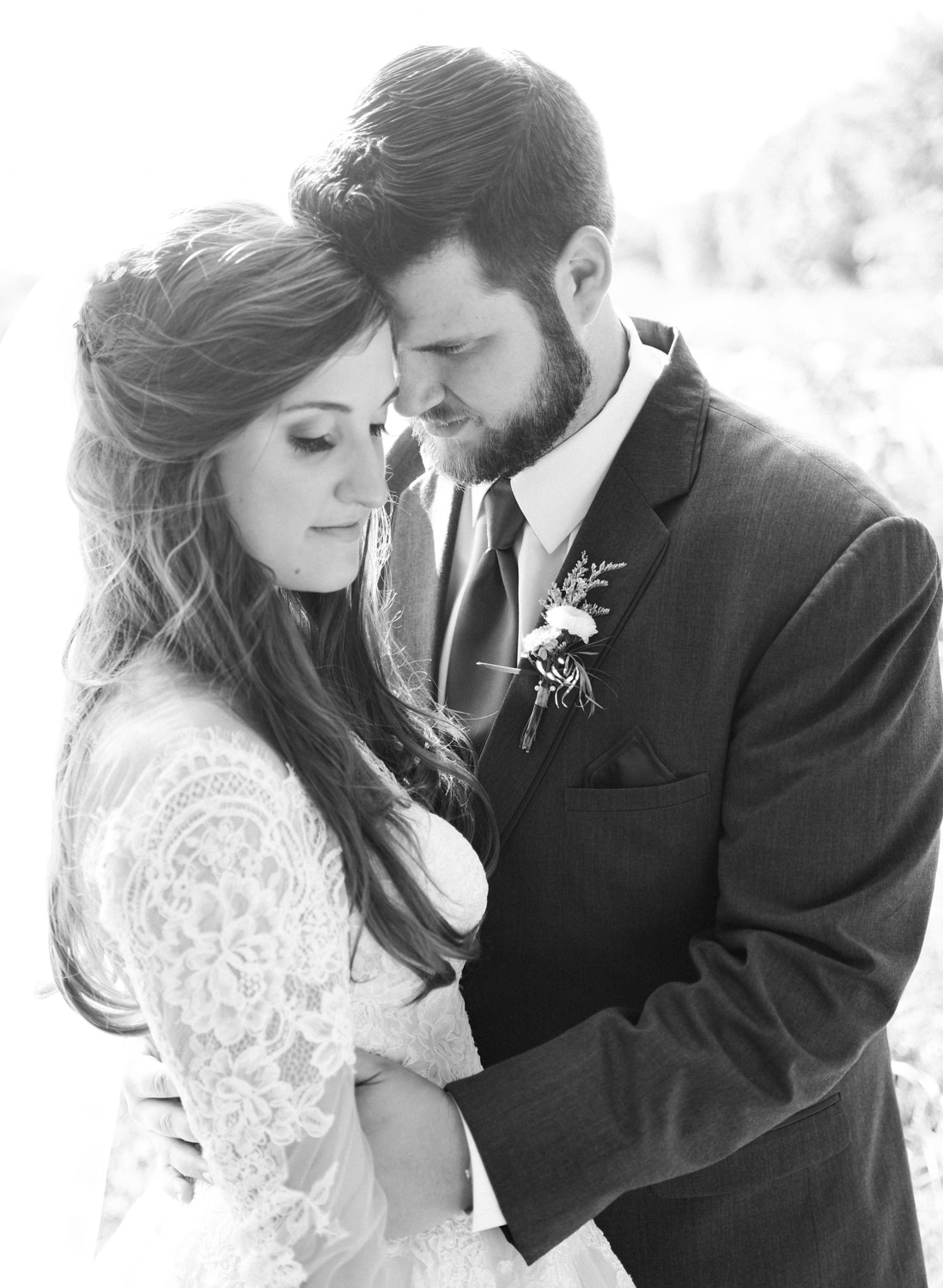 Bride and groom snuggling, black and white; St. Louis fine art film wedding photographer Erica Robnett Photography