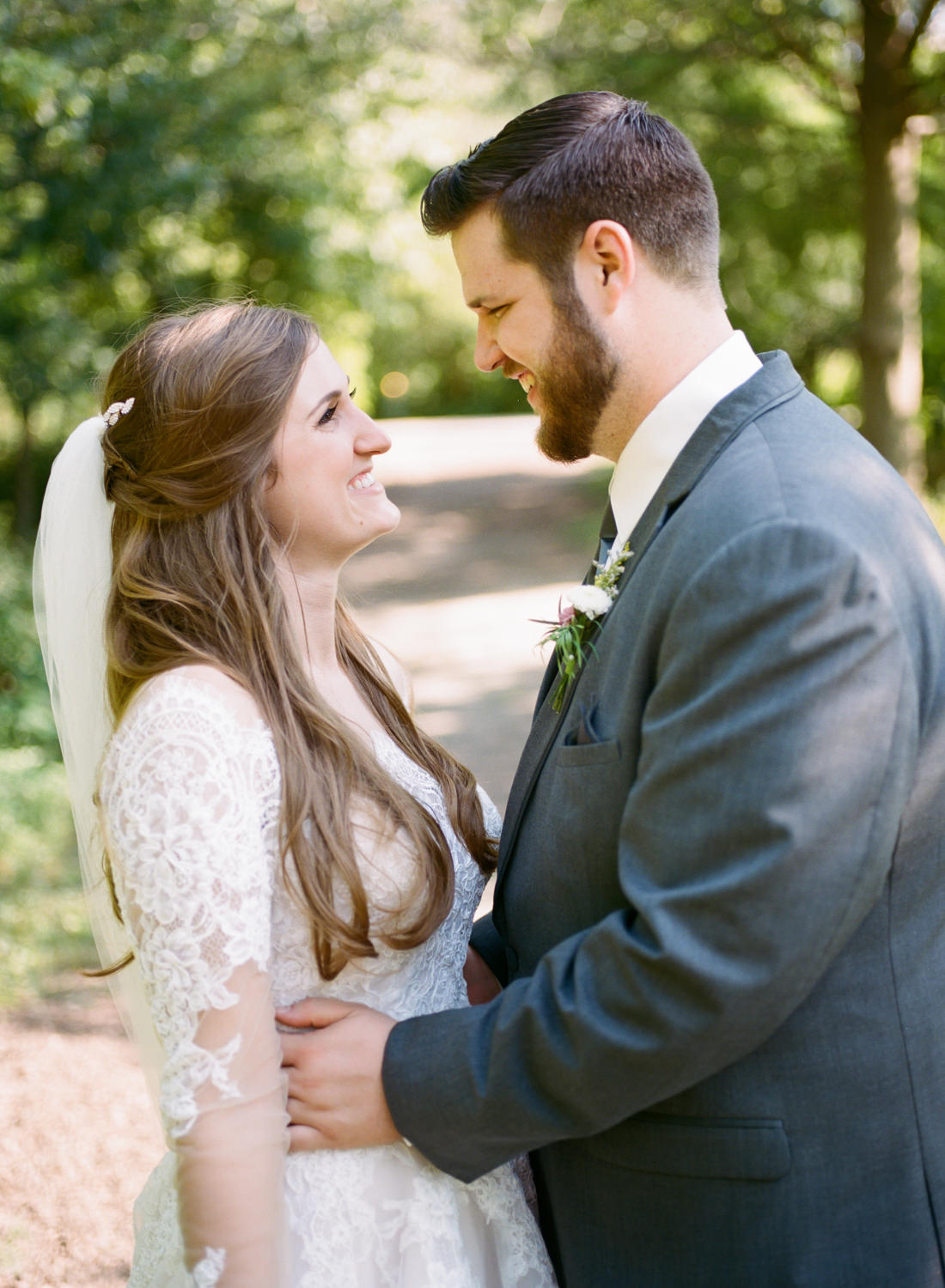 Bride and groom smiling at each other; St. Louis fine art film wedding photographer Erica Robnett Photography