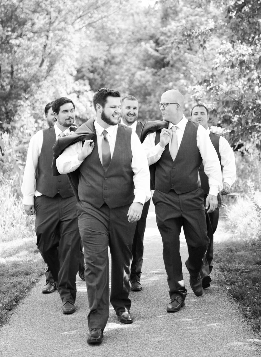Groom and groomsmen walking; St. Louis wedding photographer
