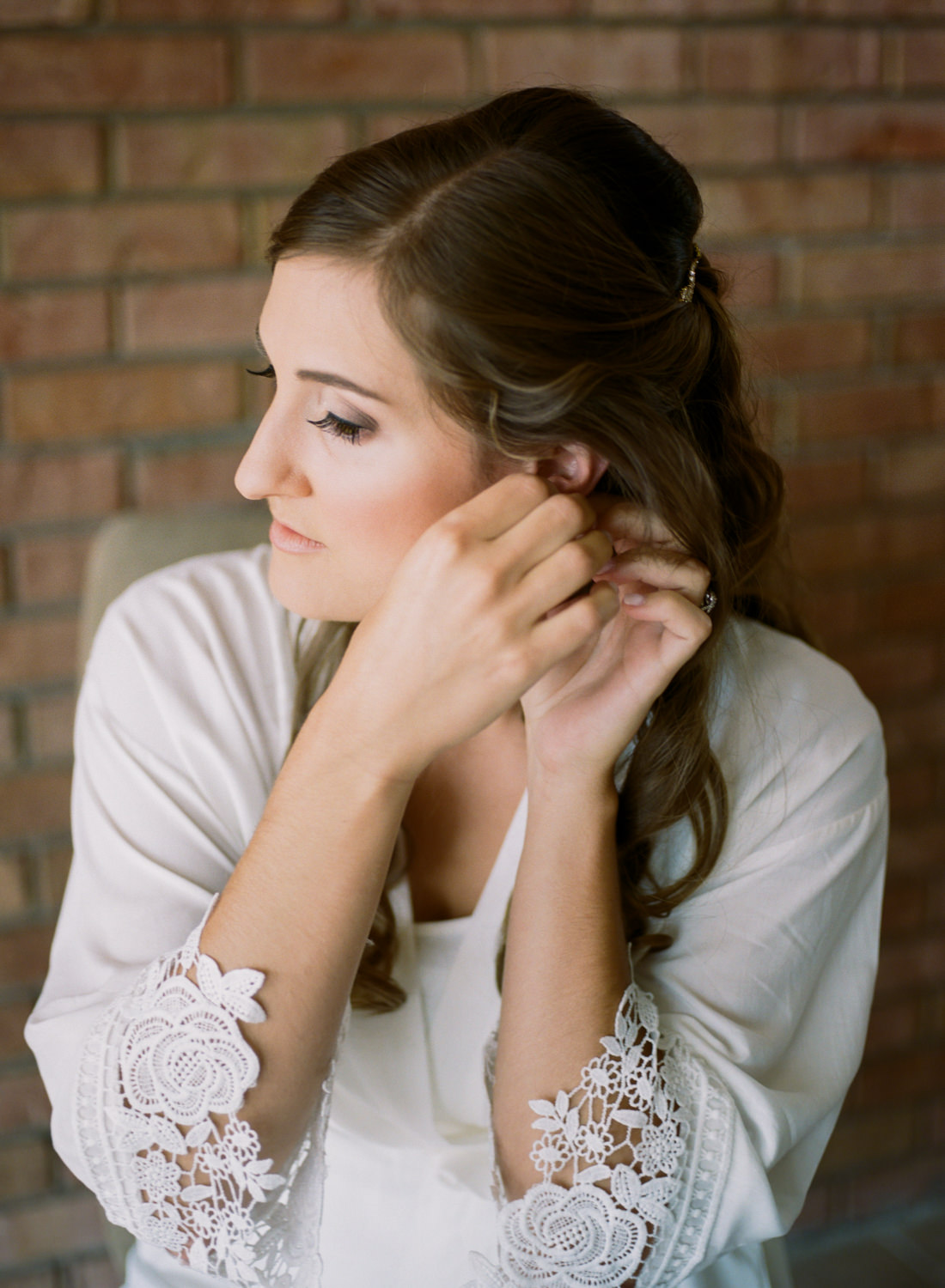 Bride putting on earrings; St. Louis wedding photographer