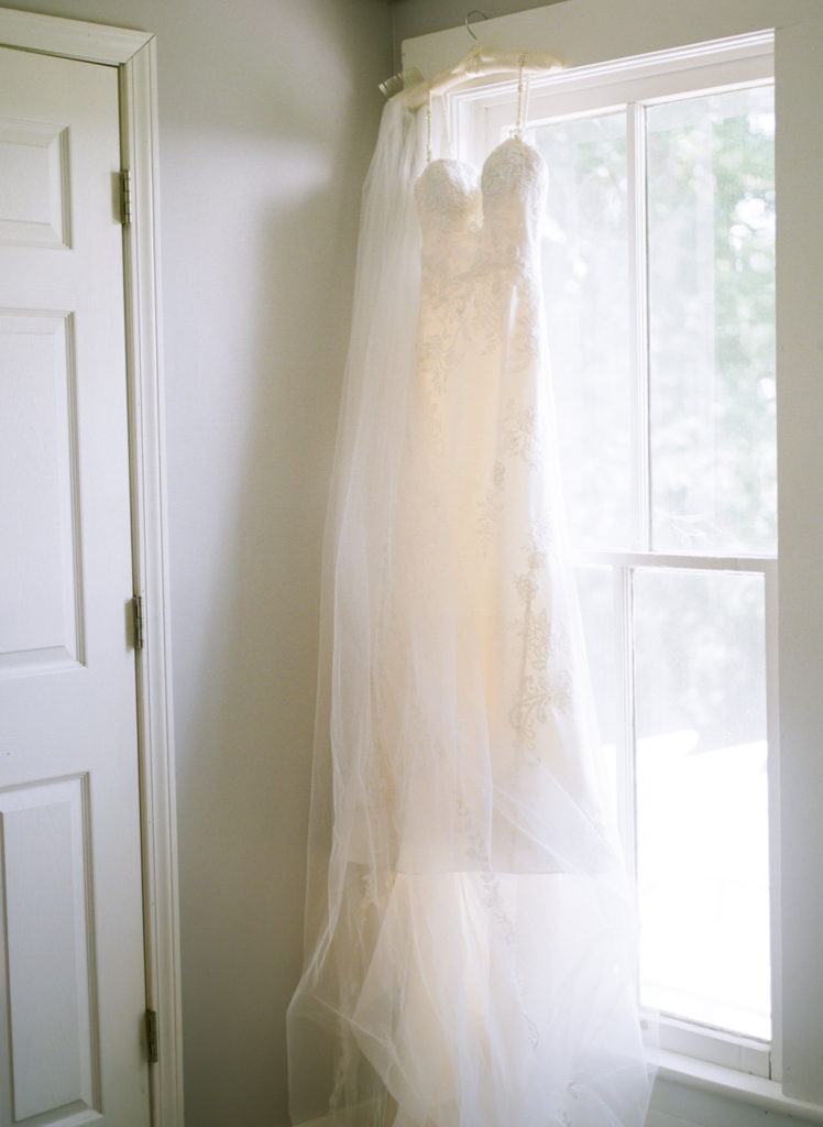 Wedding dress in window; St. Louis fine art film wedding photographer Erica Robnett Photography