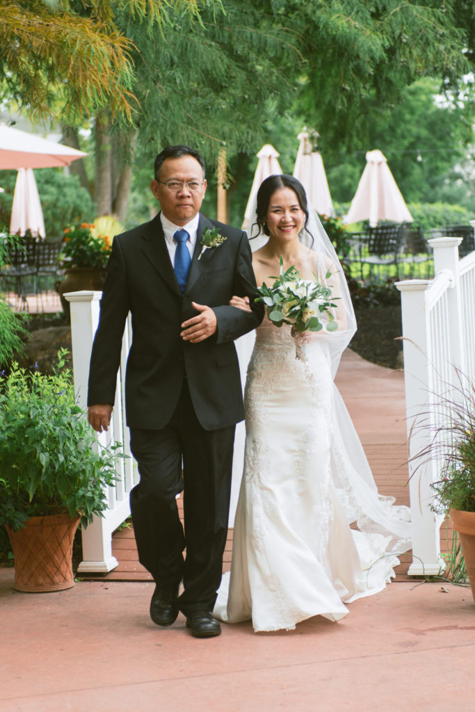 Bride walking down aisle at Defiance Ridge Vineyards