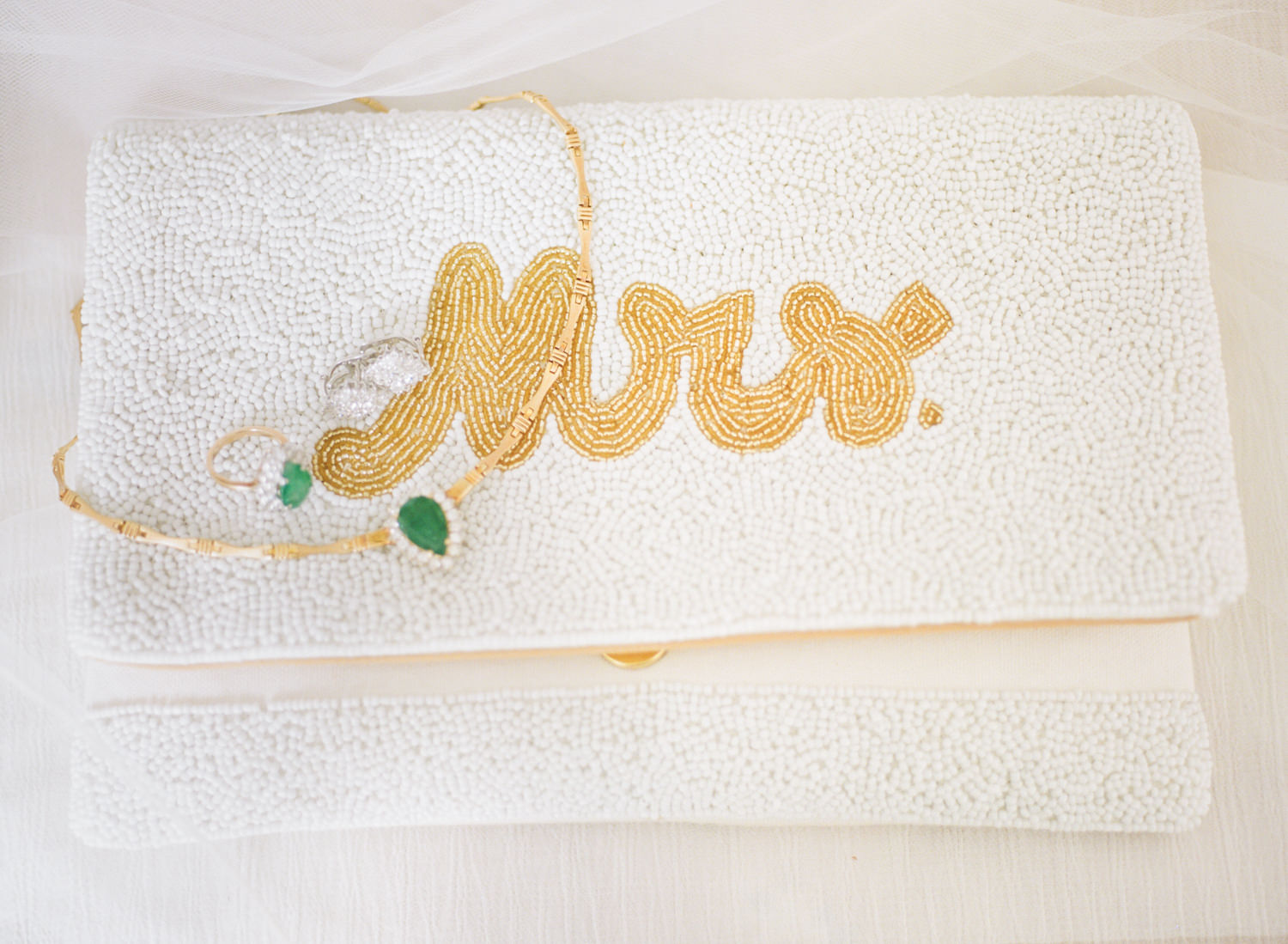 Mrs. bridal purse and green and gold jewelry; St. Louis wedding photographer