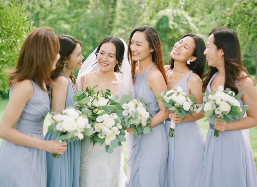 Bride and bridesmaids laughing at Defiance Ridge Vineyards; St. Louis fine art film wedding photographer Erica Robnett Photography