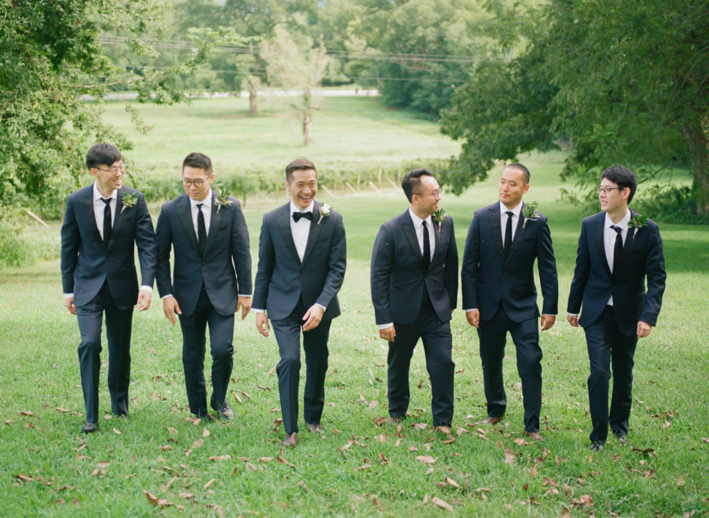 Groom and Groomsmen laughing at Defiance Ridge Vineyards; St. Louis fine art film wedding photographer Erica Robnett Photography