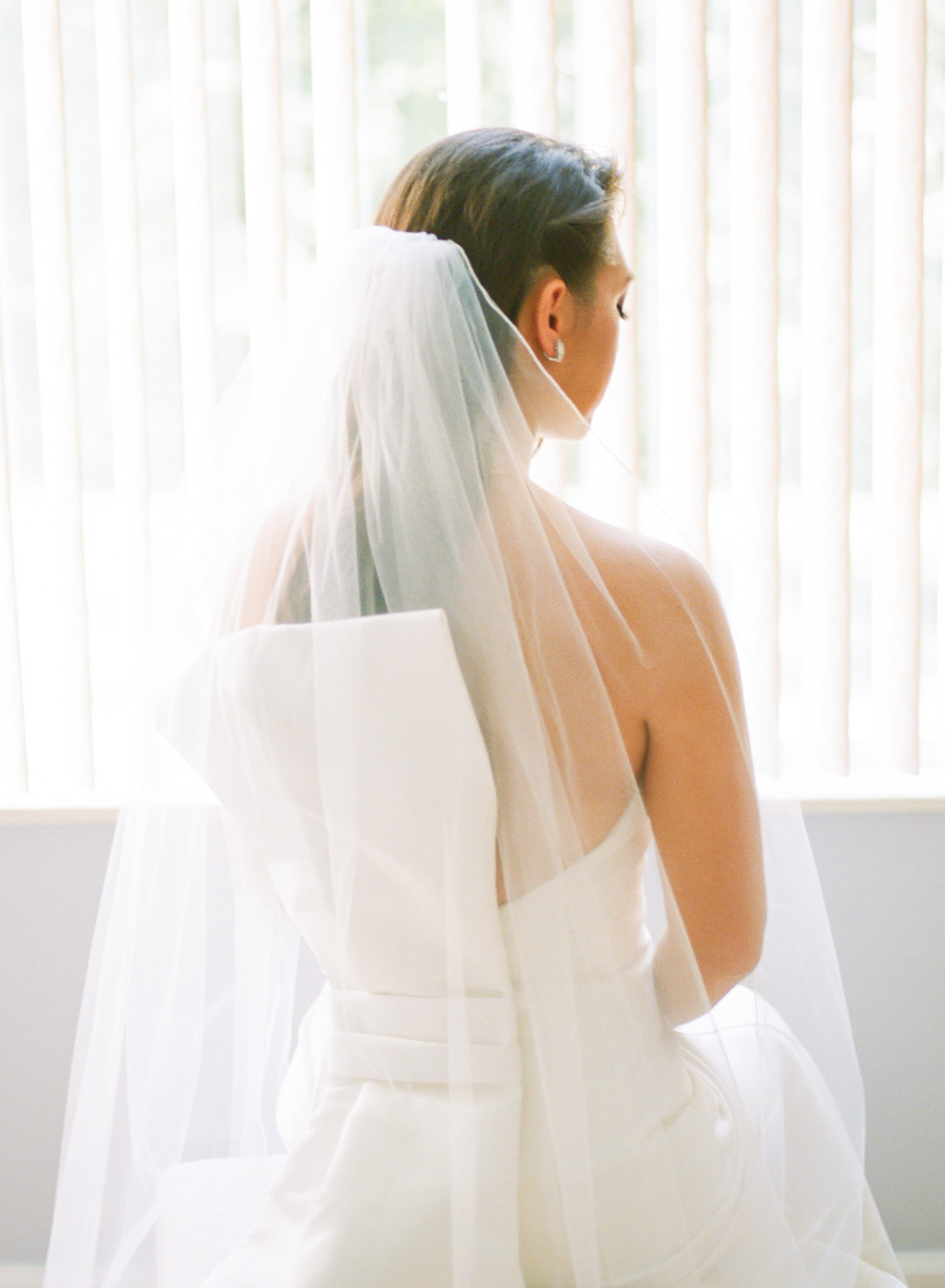 Back of brides dress with bow; St. Louis fine art film wedding photographer Erica Robnett Photography