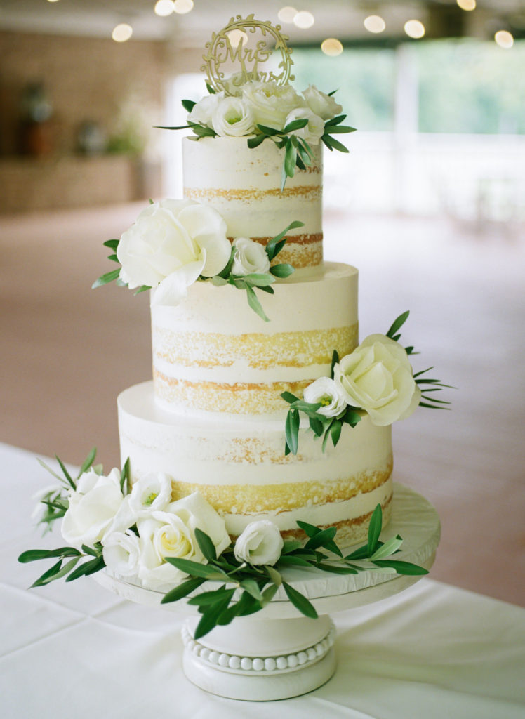 White 3 tier wedding cake with white flowers at Defiance Ridge Vineyards; St. Louis fine art film wedding photographer Erica Robnett Photography