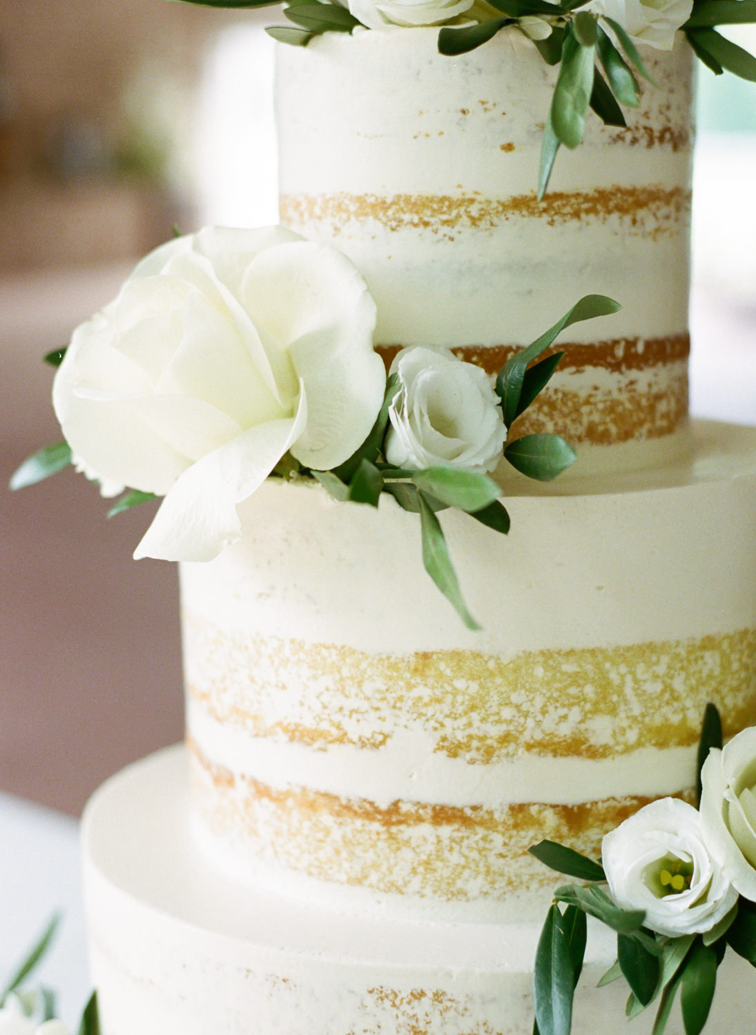 White 3 tier wedding cake with white flowers at Defiance Ridge Vineyards; St. Louis fine art film wedding photographer Erica Robnett Photography