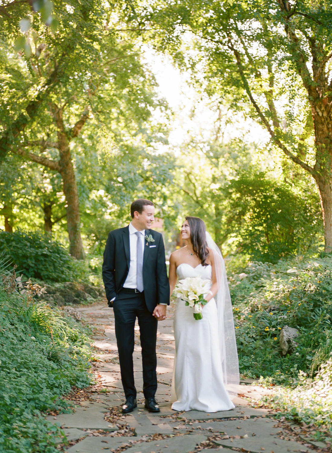 Bride and groom portrait in sunlight on Lafayette Park path; St. Louis fine art film wedding photographer Erica Robnett Photography
