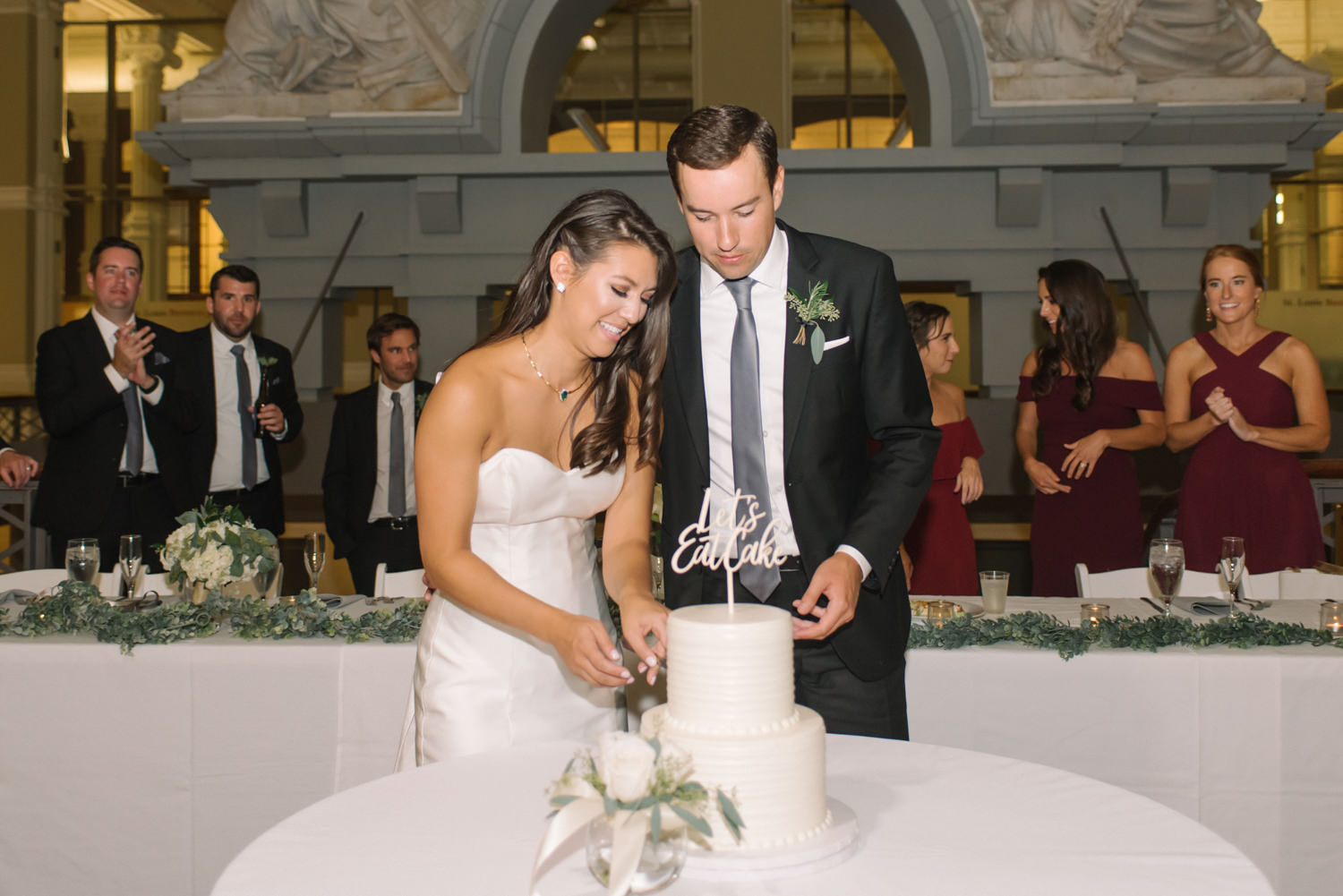 Bride and groom cutting cake at St. Louis Old Post Office and Custom House; St. Louis fine art film wedding photographer Erica Robnett Photography
