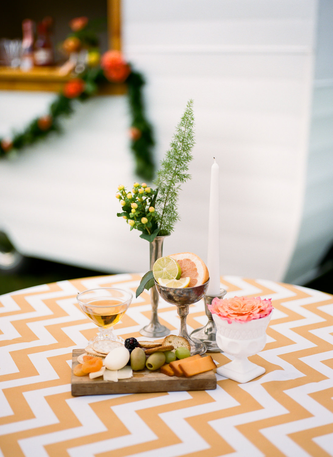 Colorful orange and yellow cocktail hour decor and food at Missouri wedding venue Emerson Fields; St. Louis Fine art film wedding photographer Erica Robnett Photography