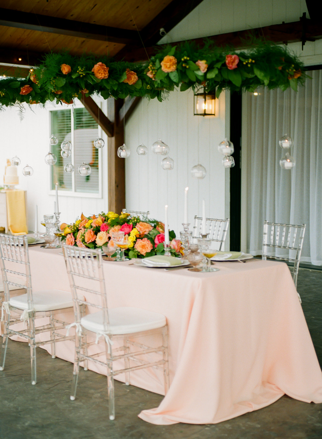 Colorful peach, orange and yellow reception table decor at Missouri wedding venue Emerson Fields; St. Louis Fine art film wedding photographer Erica Robnett Photography