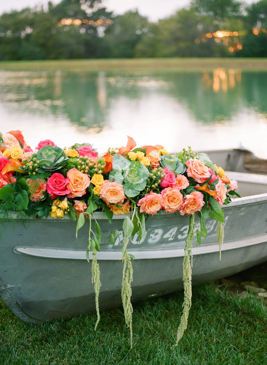 Boat with brightly colored peach, orange, and yellow flowers at Missouri wedding venue Emerson Fields; St. Louis fine art film wedding photographer Erica Robnett Photography
