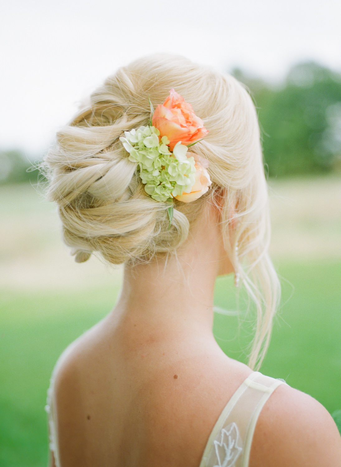 Bridal updo with brightly colored flowers; St. Louis fine art film wedding photographer Erica Robnett Photography