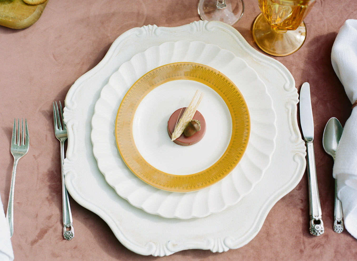 Colored glass, acorn and wheat decorated chocolates, vintage wheat patterned china, rose velvet tablecloth; Thanksgiving table at Emerson Fields; St. Louis fine art film wedding photographer Erica Robnett Photography