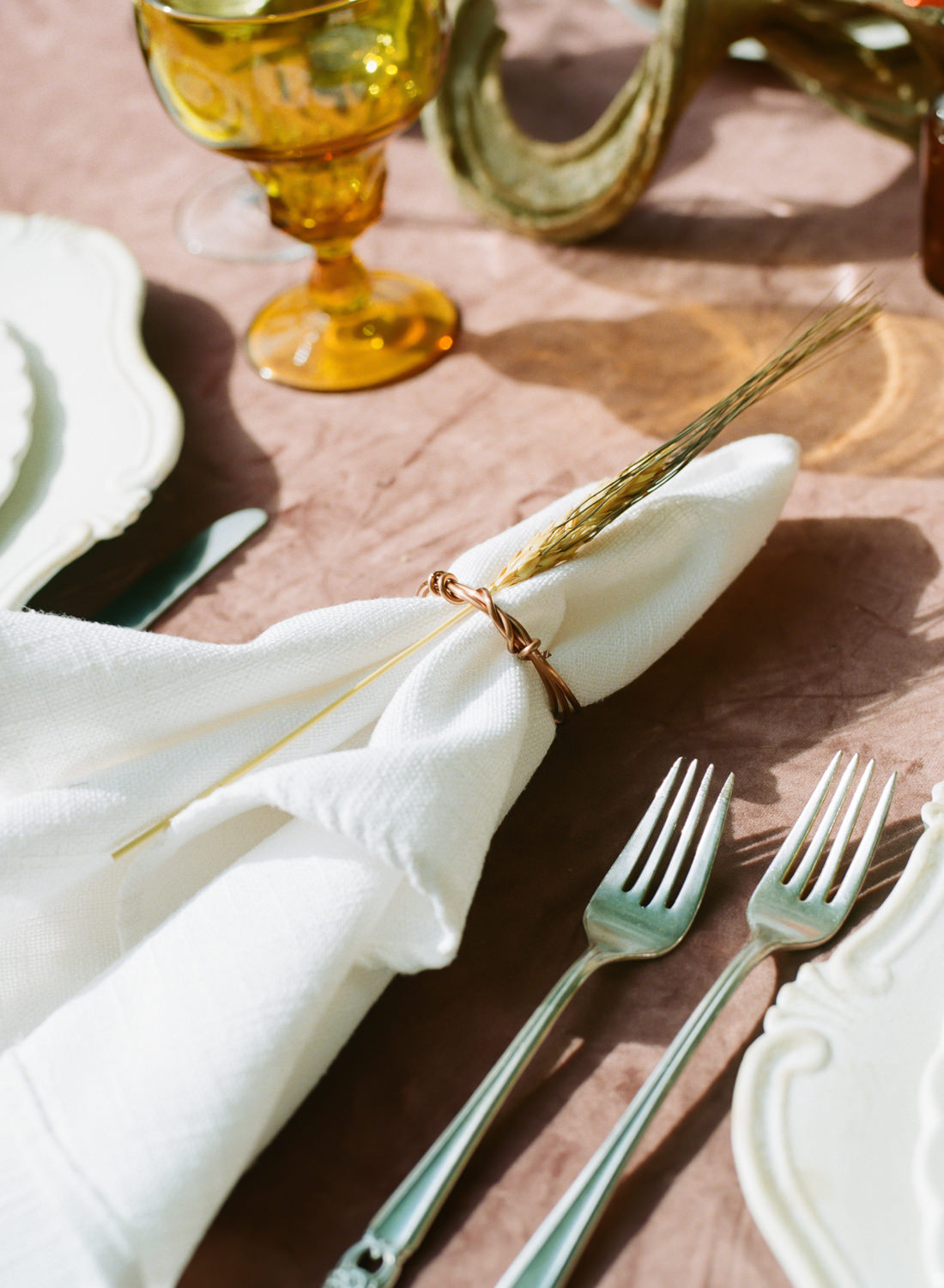Amber colored glass, white napkins with wheat decor accent, vintage china, rose velvet tablecloth, pumpkin decor; Thanksgiving table at Emerson Fields; St. Louis fine art film wedding photographer Erica Robnett Photography