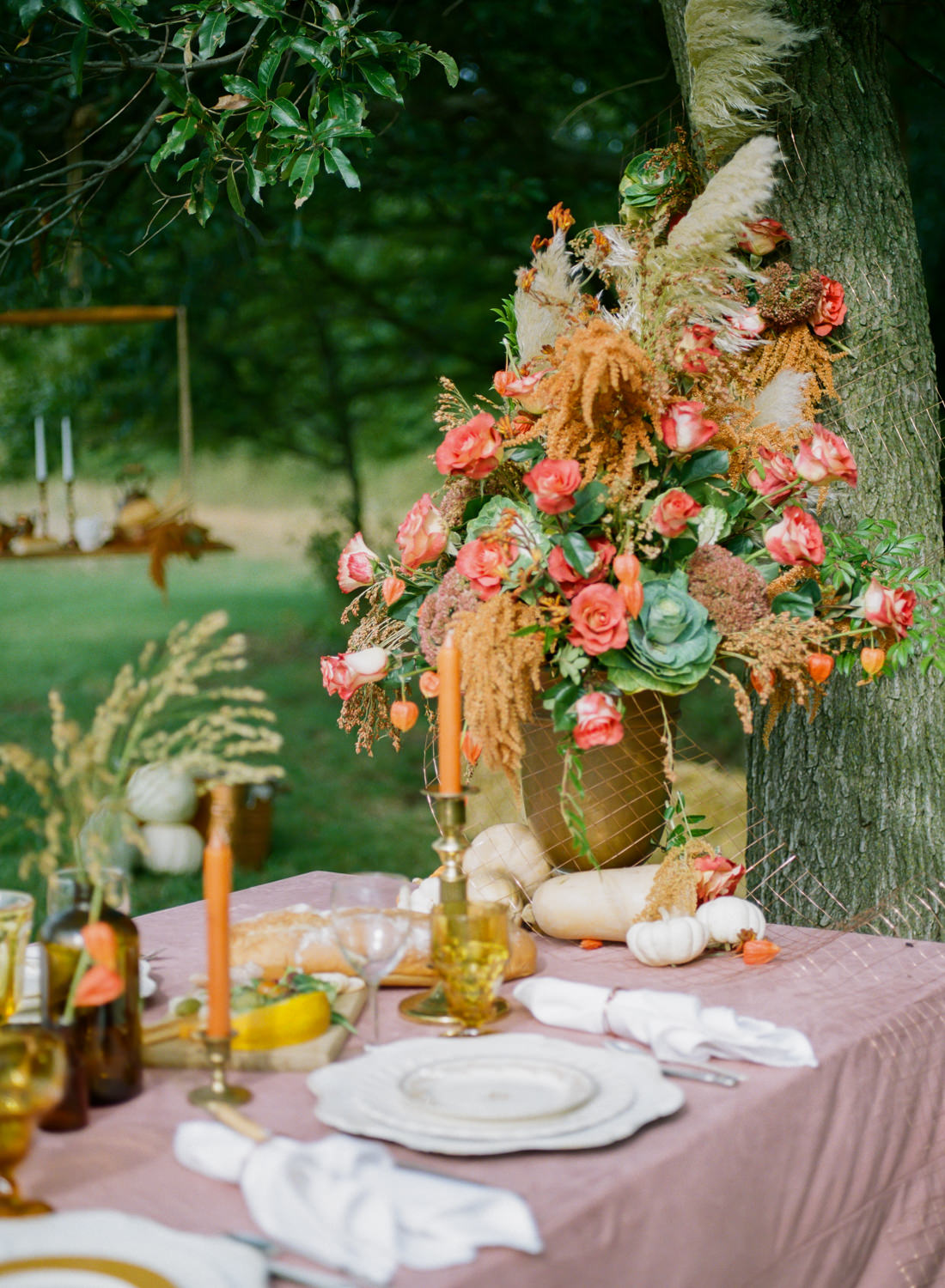 Colored glass, orange taper candles, orange and red autumn florals, vintage china, rose velvet tablecloth, pumpkin decor; Thanksgiving table at Emerson Fields; St. Louis fine art film wedding photographer Erica Robnett Photography
