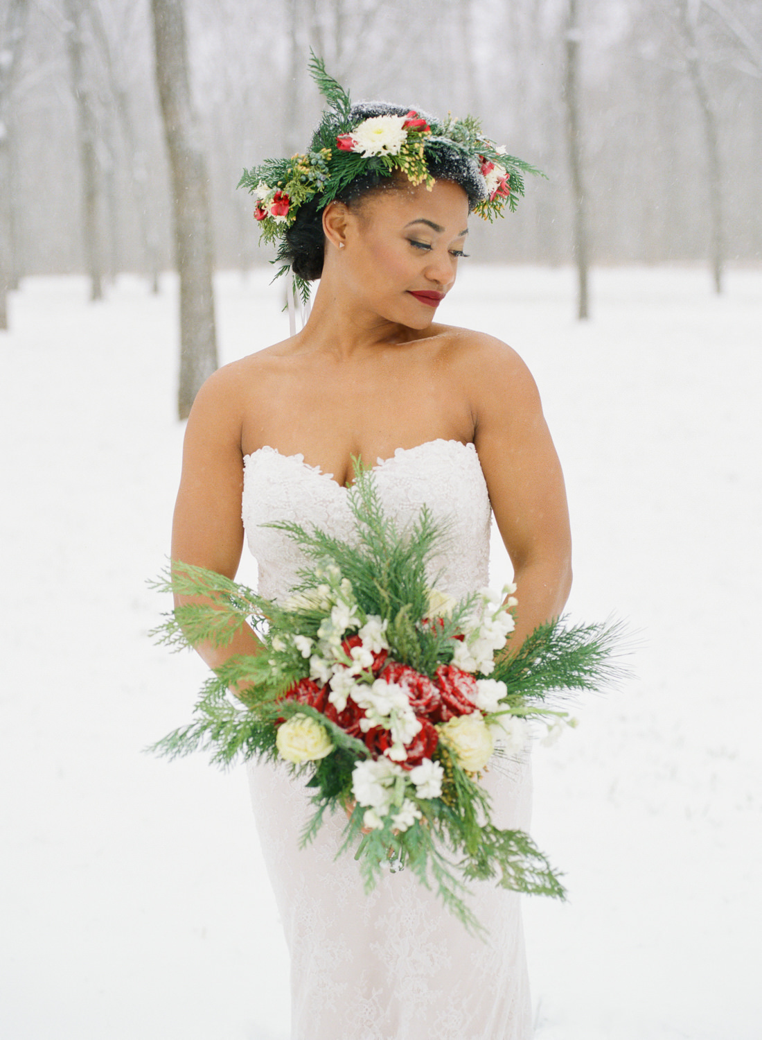 Winter wedding bride with holiday bouquet and flower crown in snow; St. Louis fine art film wedding photographer Erica Robnett Photography