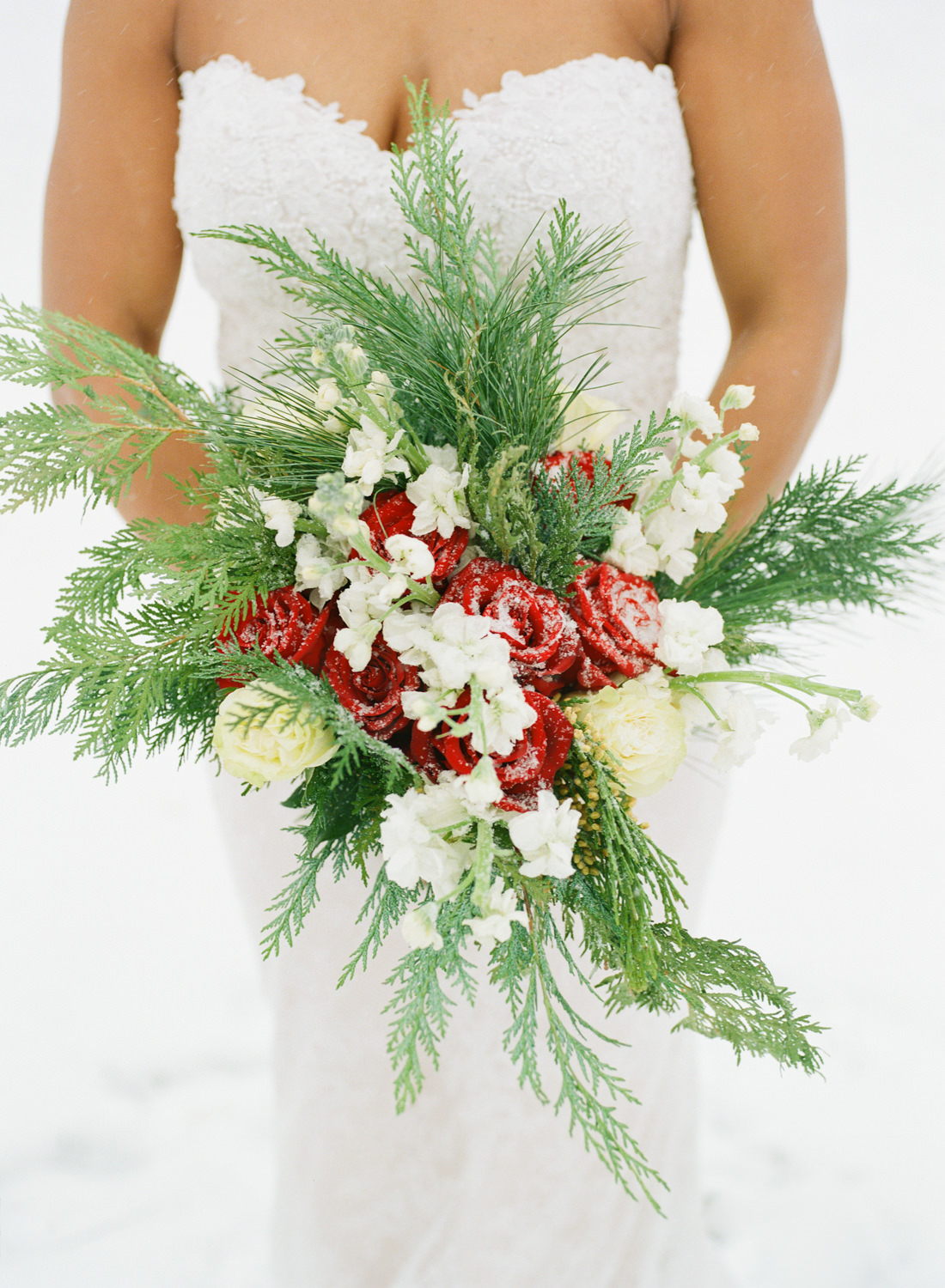Winter Winter wedding, red rose and spruce Christmas bridal bouquet; St. Louis fine art film wedding photographer Erica Robnett Photography