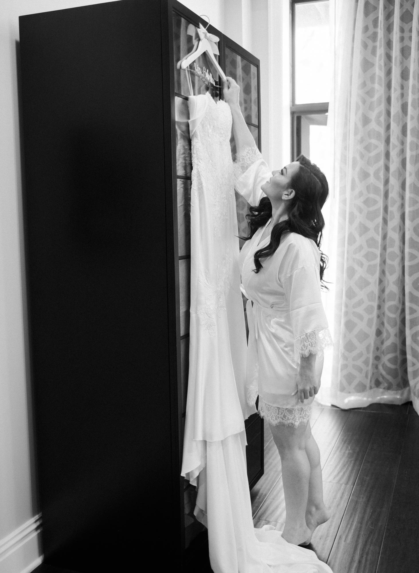Bride reaching for her wedding gown
