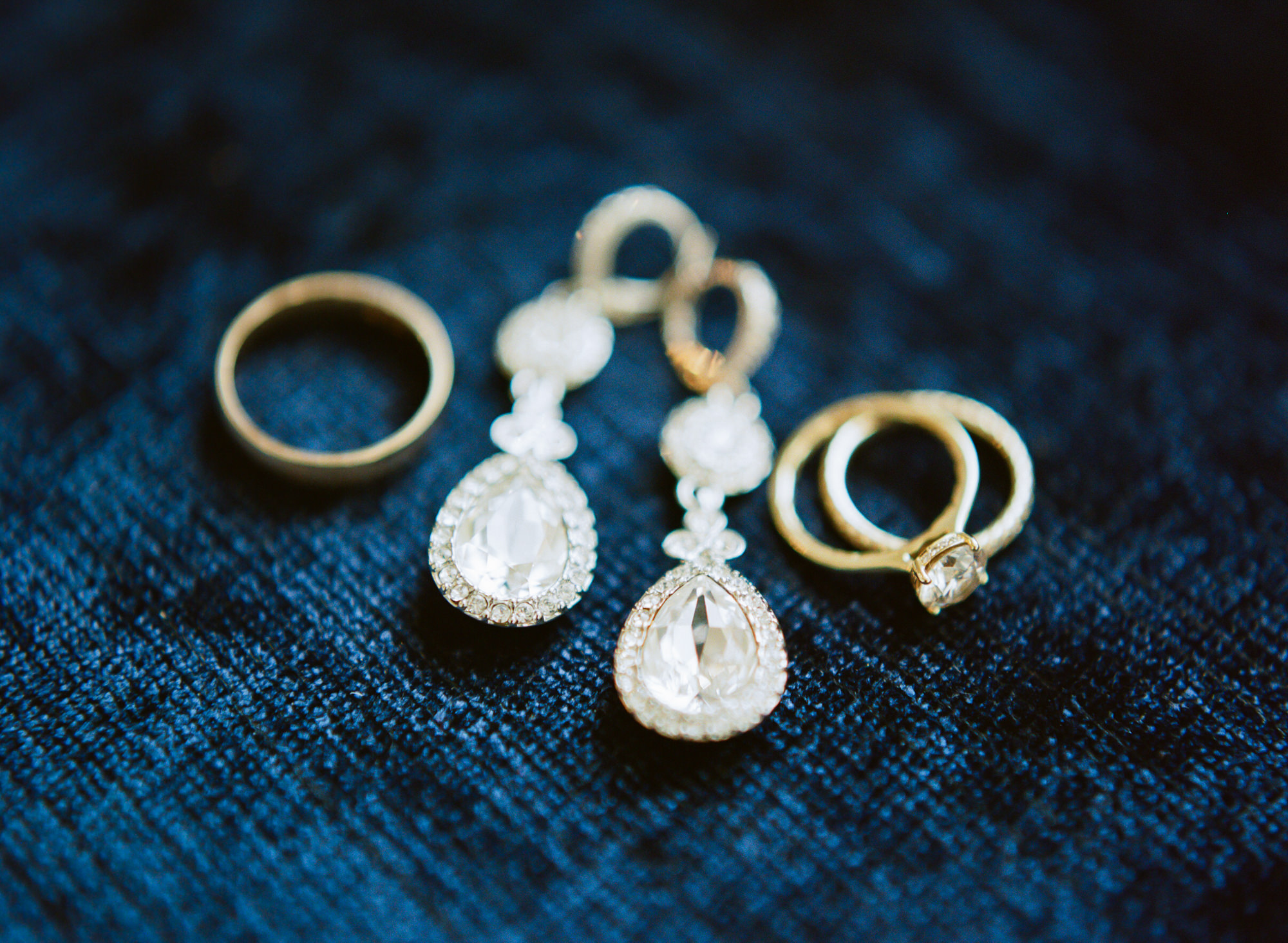 Gold wedding bands and diamond earrings; St. Louis fine art film wedding photographer Erica Robnett Photography