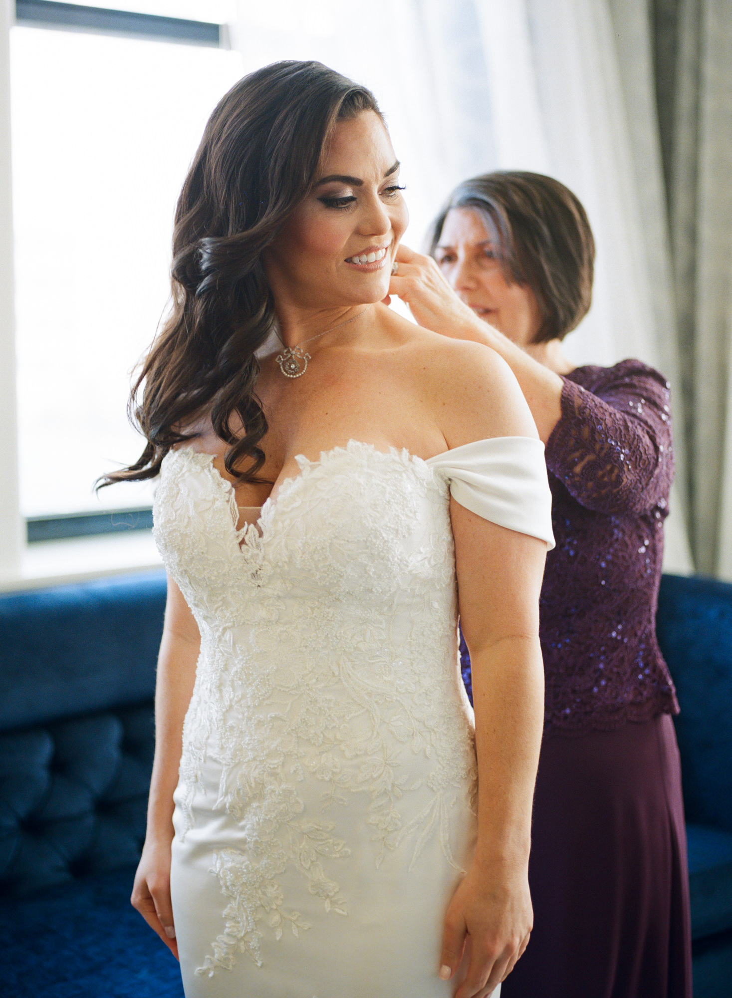 Mother of bride helping bride with jewelry; St. Louis fine art film wedding photographer Erica Robnett Photography