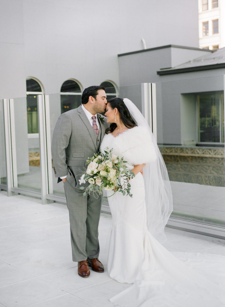 Winter bride and groom portrait on rooftop of Hotel St. Louis; St. Louis fine art film wedding photographer Erica Robnett Photography