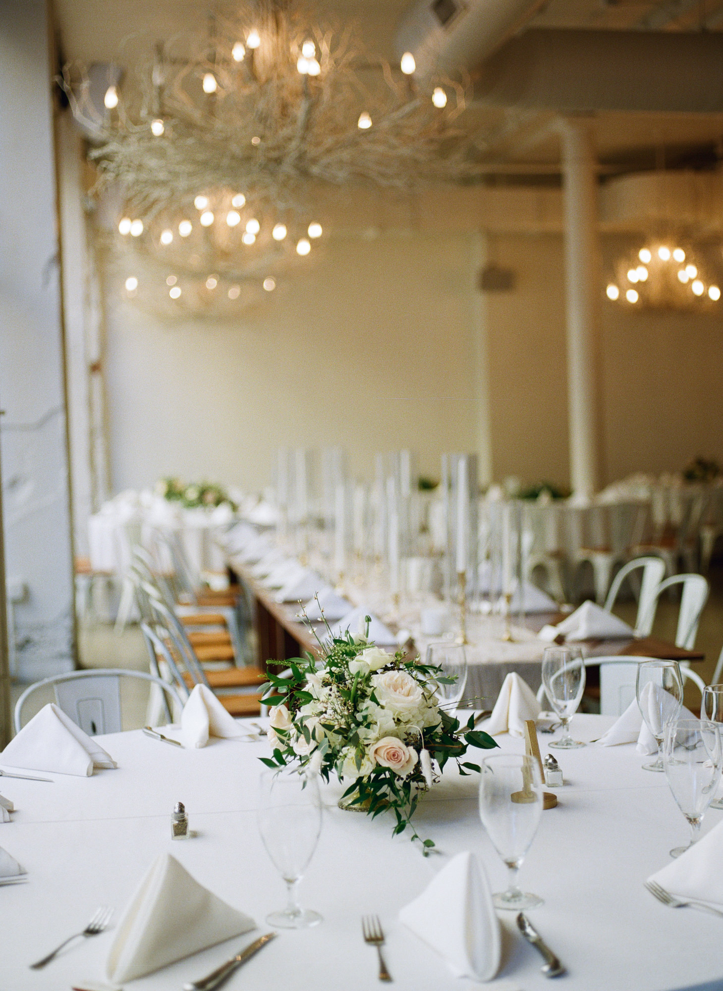 White flowers and candle vases decor at Willow St. Louis wedding reception; St. Louis fine art film wedding photographer Erica Robnett Photography