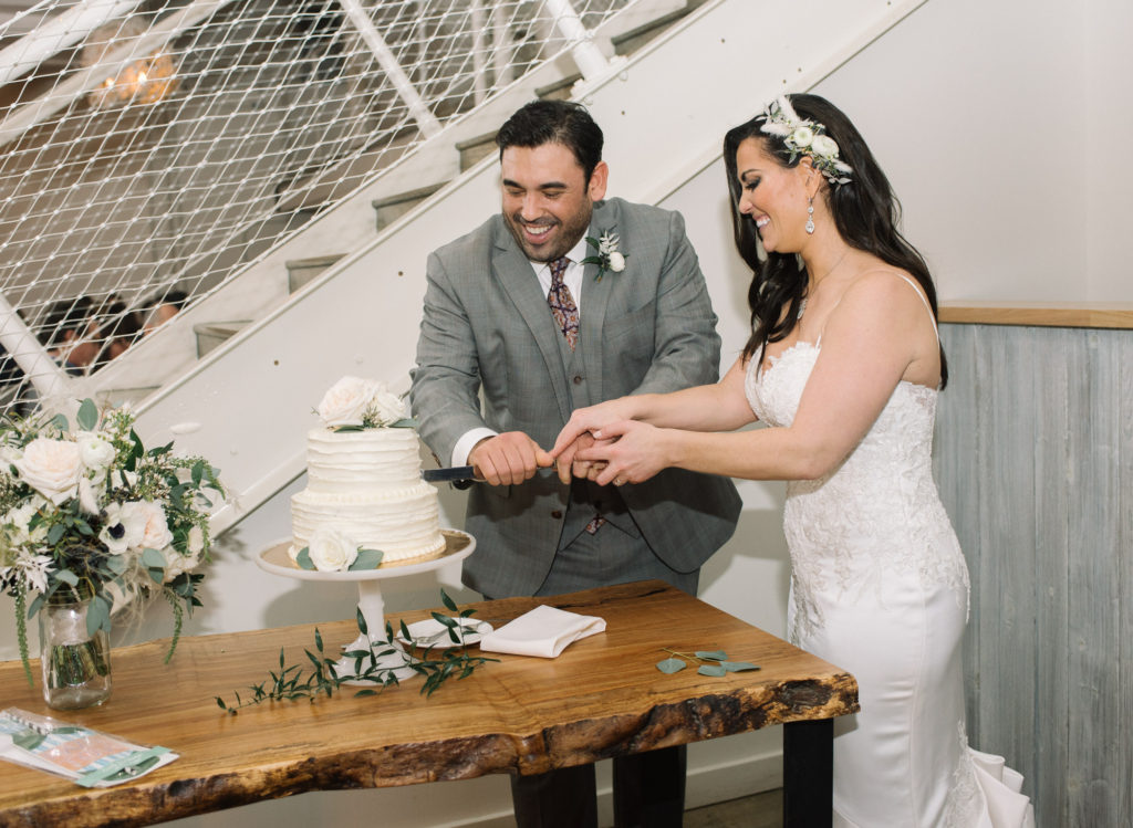 Bride and groom cutting cake at St. Louis wedding venue Willow; St. Louis wedding photographer
