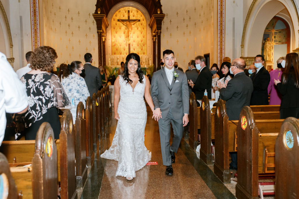 Bride and groom exiting St. John Paul II in St. Louis