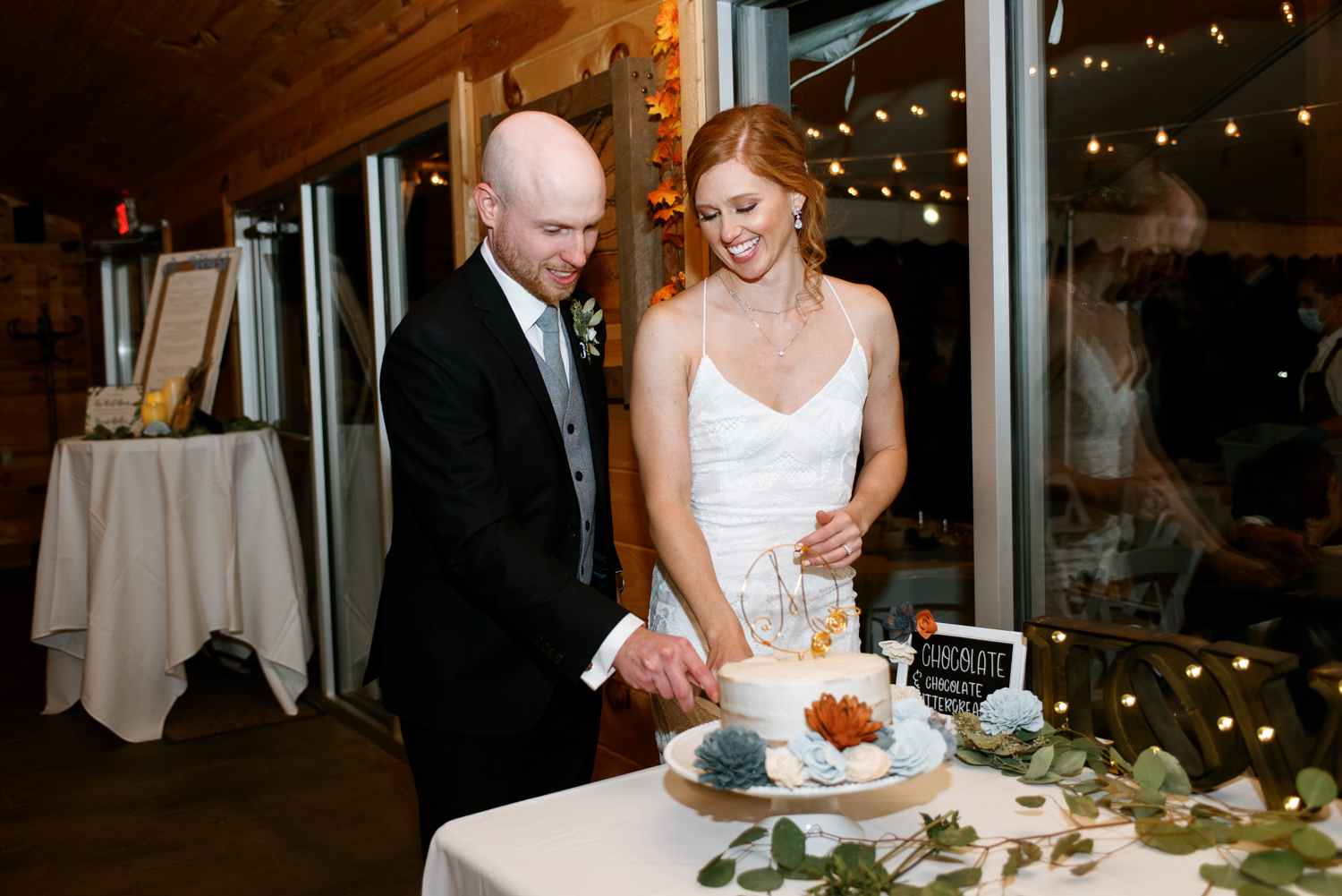 Bride and groom cutting cake at St. Charles Missouri wedding venue Glenmark Farms