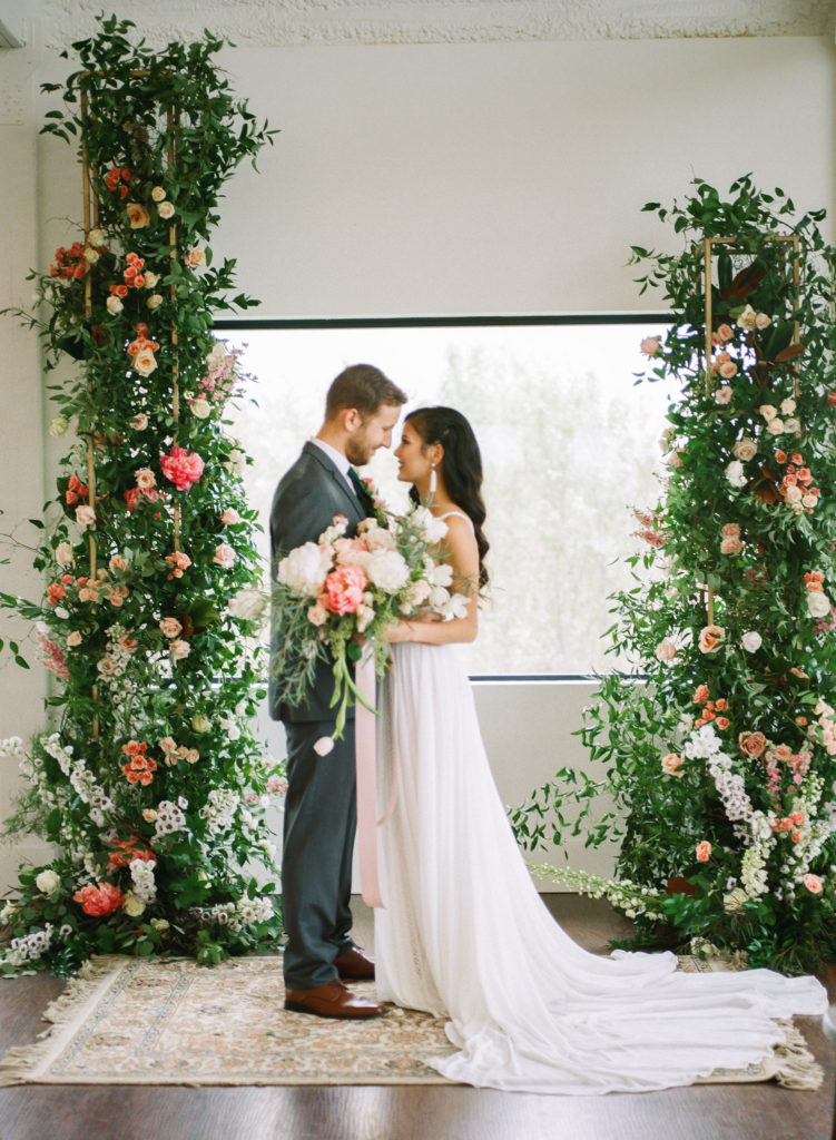 Wedding with floral ceremony backdrop; St. Louis wedding photographer